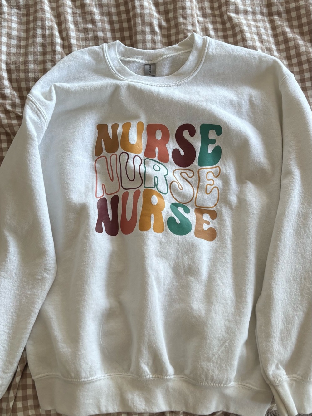 Gildan White Crewneck Sweatshirt with Multicolor "NURSE" Graphic